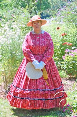 Marge Bucholz poses in the Butterfly & Bee Garden 